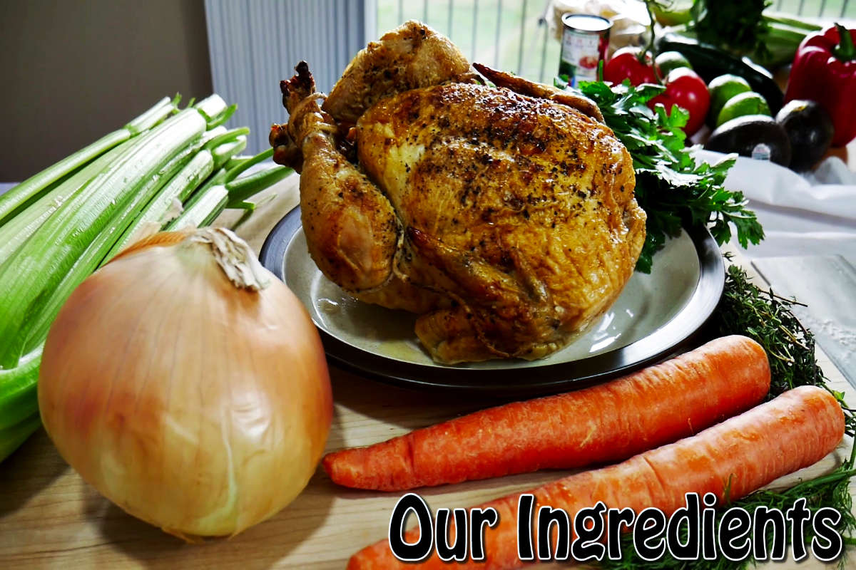 Ingredients for chicken stock. Onion, carrots, celery, chicken bones, parsley, thyme, dill, black pepper, and bay leaf.