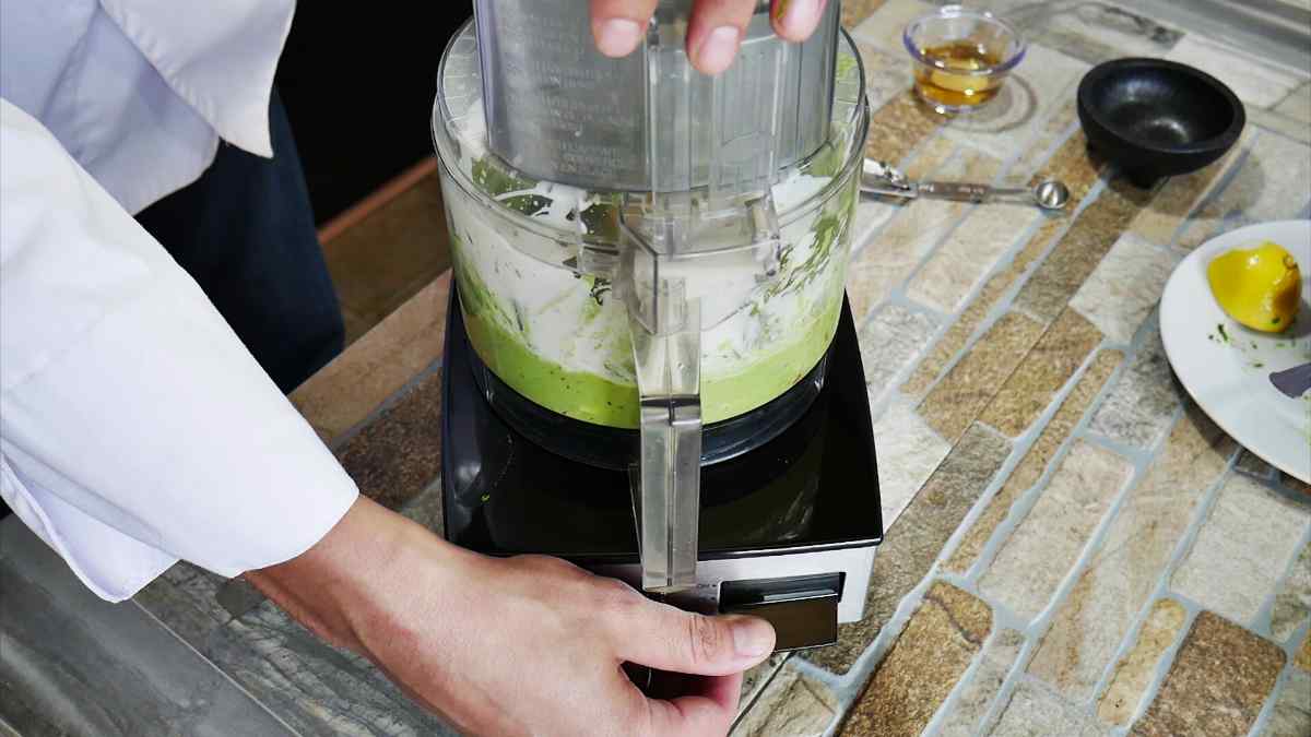 Making the Avocado crema in a food processor. You can see the bright green color from the avocado.