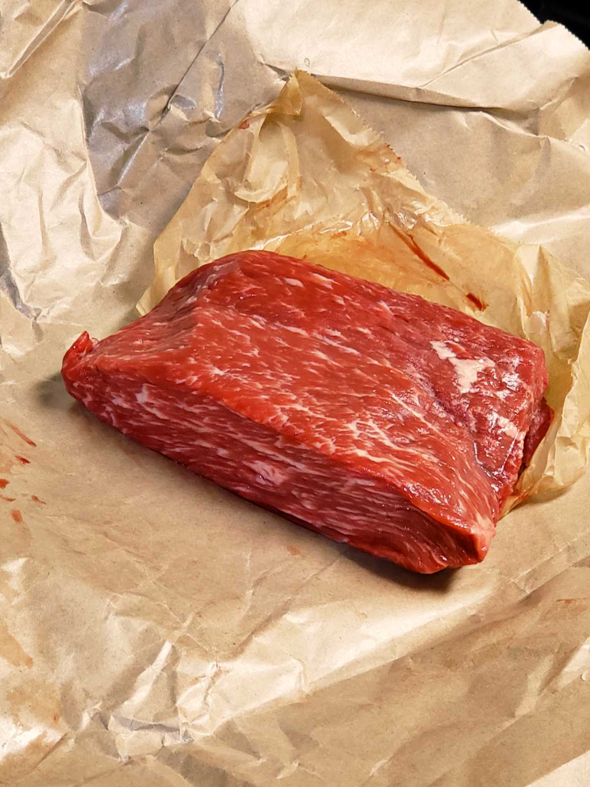 Flap meat on butcher paper. The meat has great marbling.