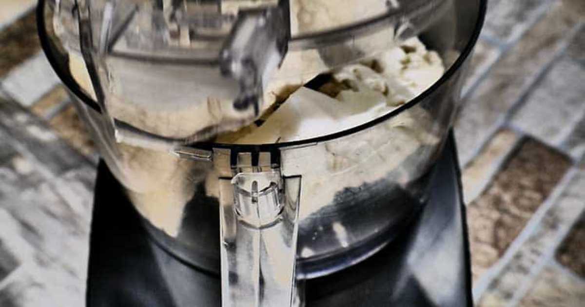 Cauliflower being chopped in food processor.
