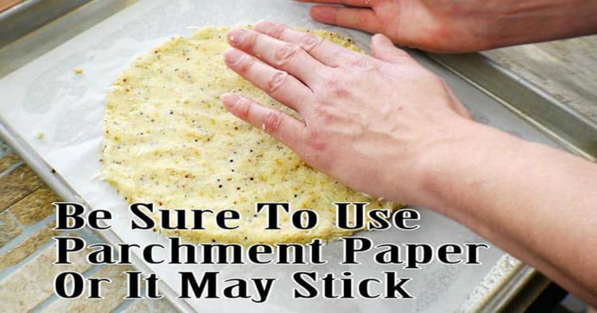 Chef shaping and flattening the cauliflower pizza crust using their hands.
