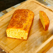 Keto bread loaf sliced on cutting board.