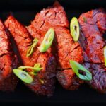 Instant Pot Steak plated with sliced green onion garnish.