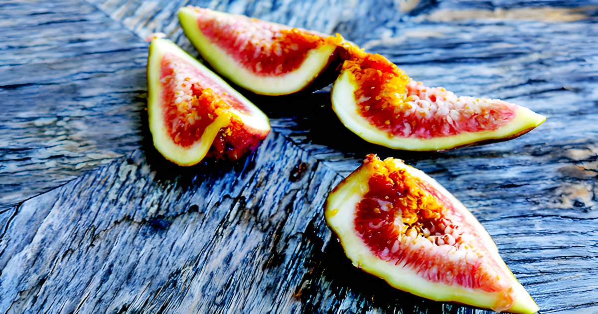 Fresh Figs sliced into quarters on rustic wood.