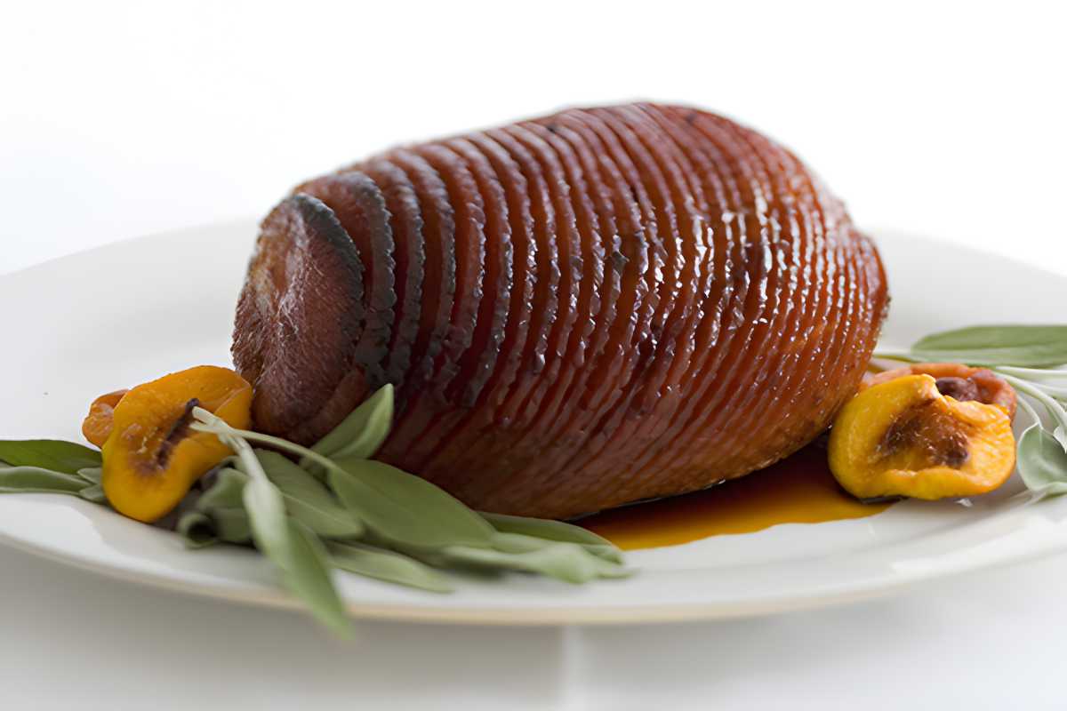 Bayonne Ham sliced on white serving plate.