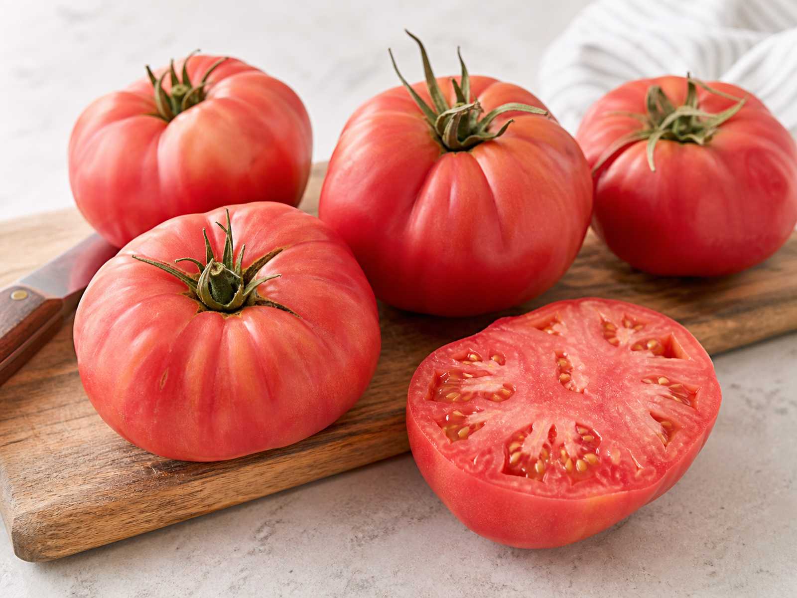 Brandywine heirloom tomatoes with pink-red beefsteak shape and sliced meaty flesh