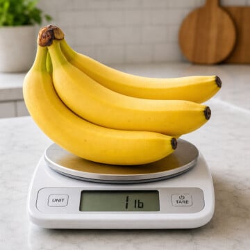 Three bananas on a digital kitchen scale reading one pound.