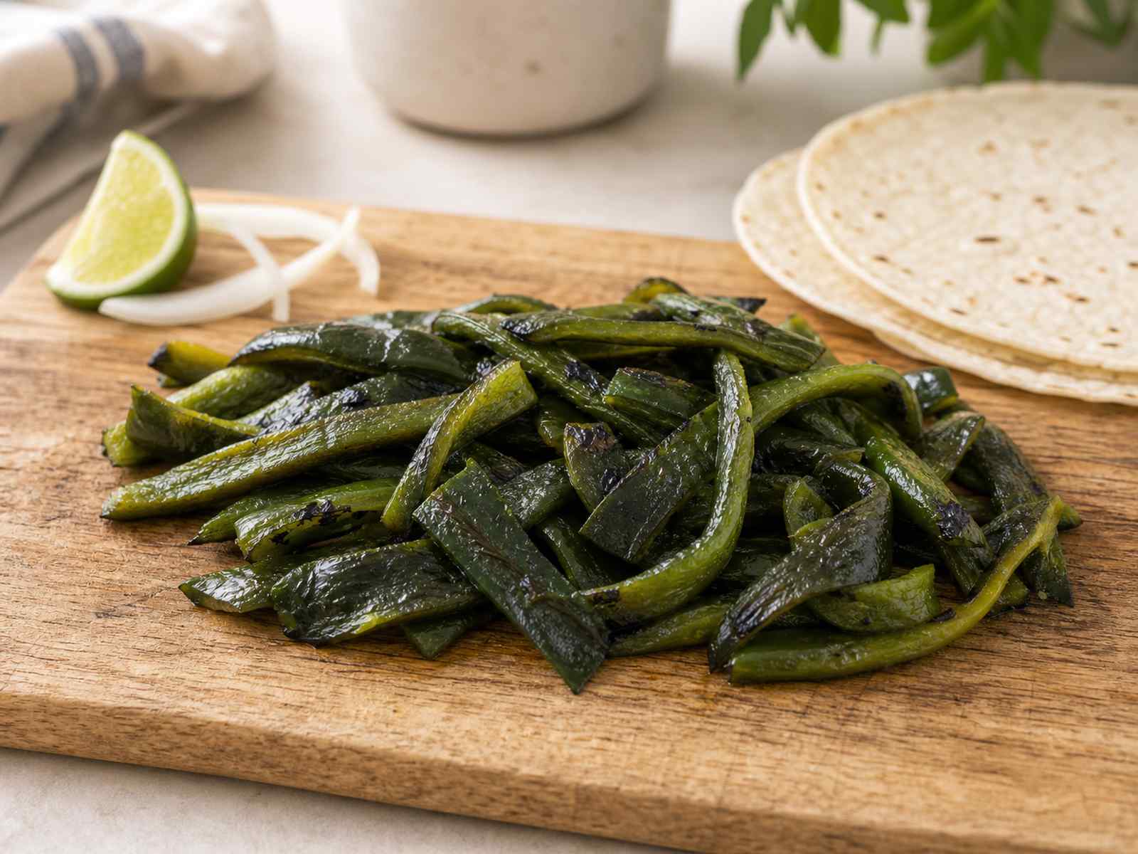 Roasted poblano strips on a wooden cutting board