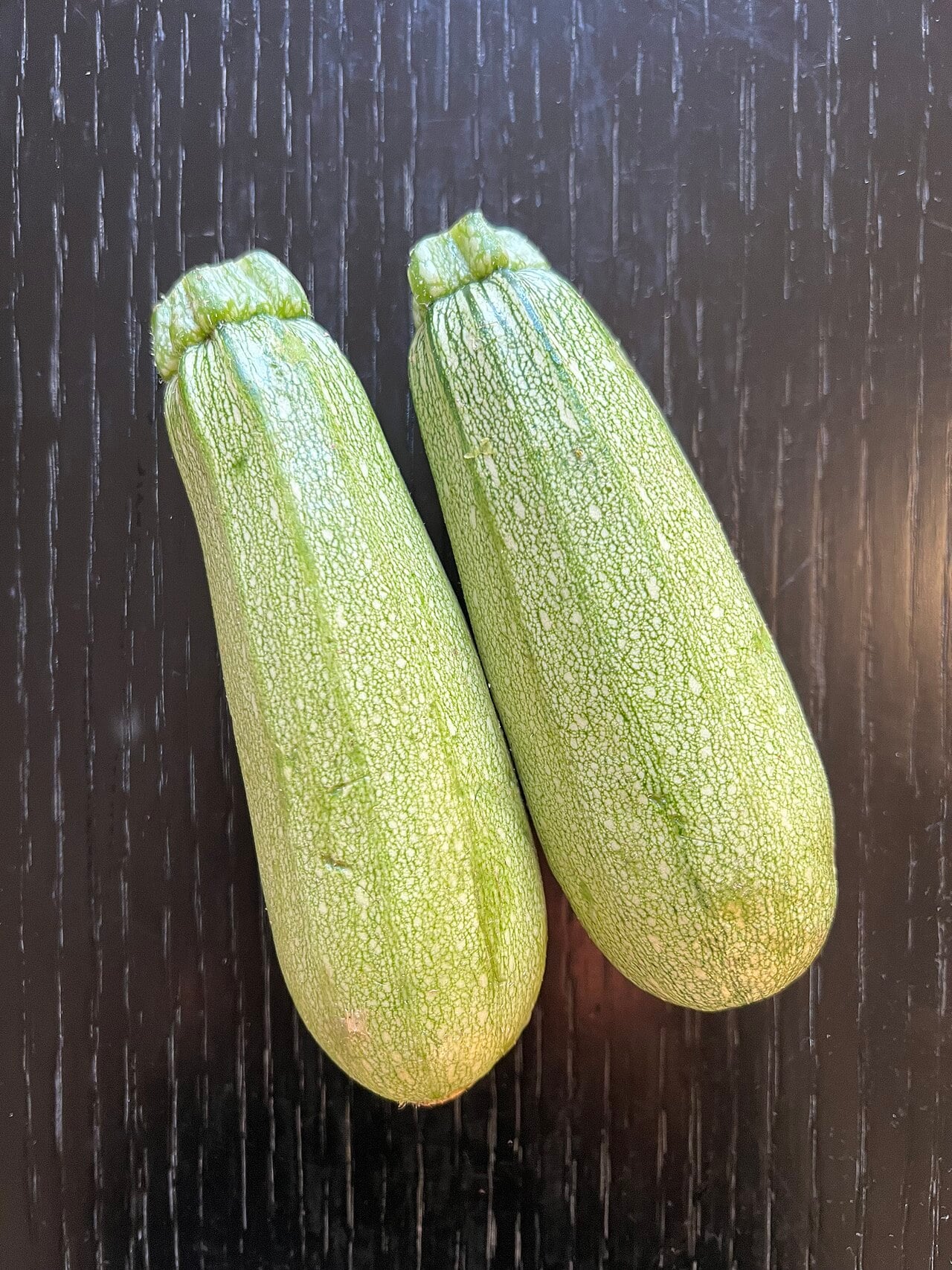 Two pale green Lebanese summer squash